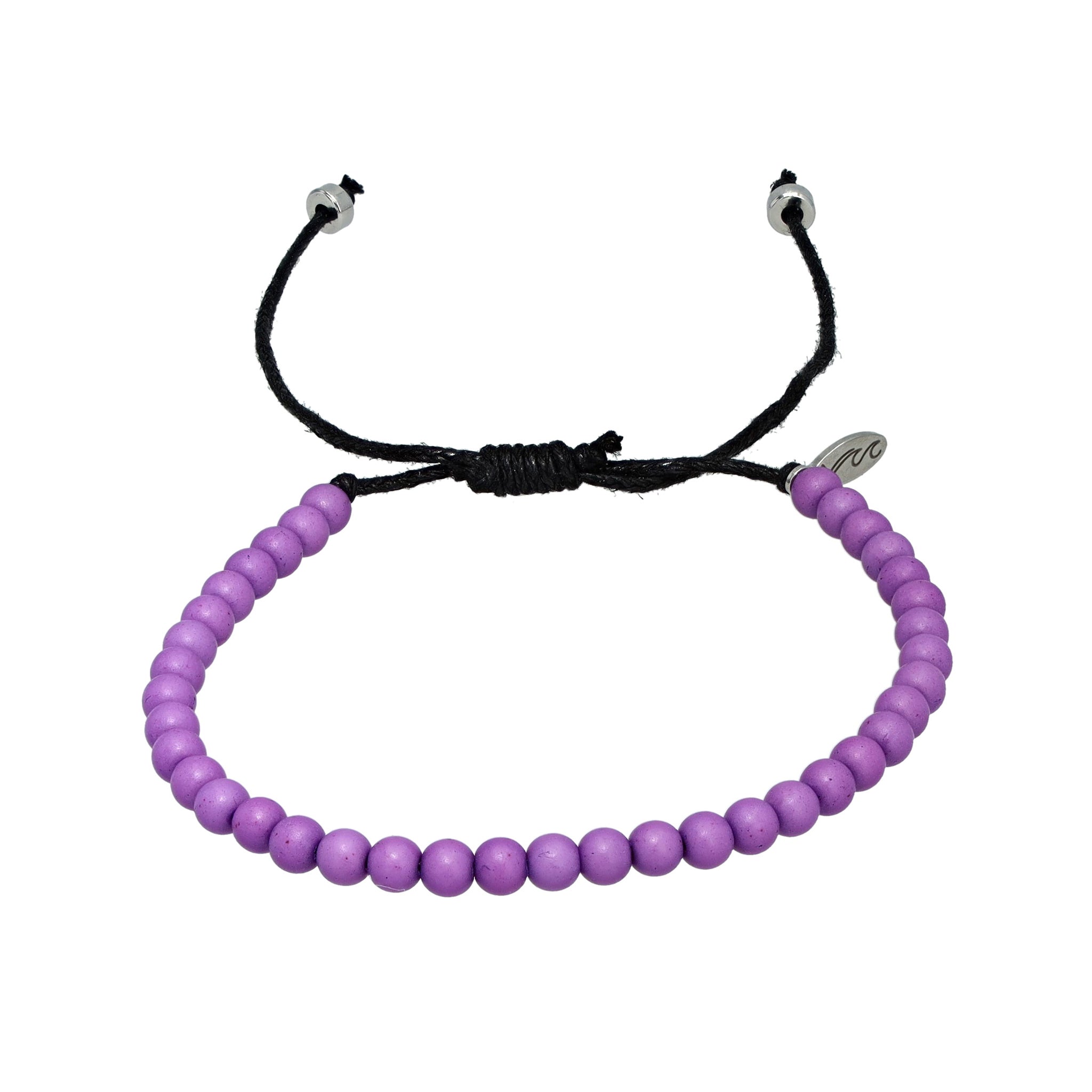 Light purple recycled ocean plastic bracelet with a minimalist charm and adjustable cotton cord. Handmade in Bali to support cleaner oceans and sustainable jobs.