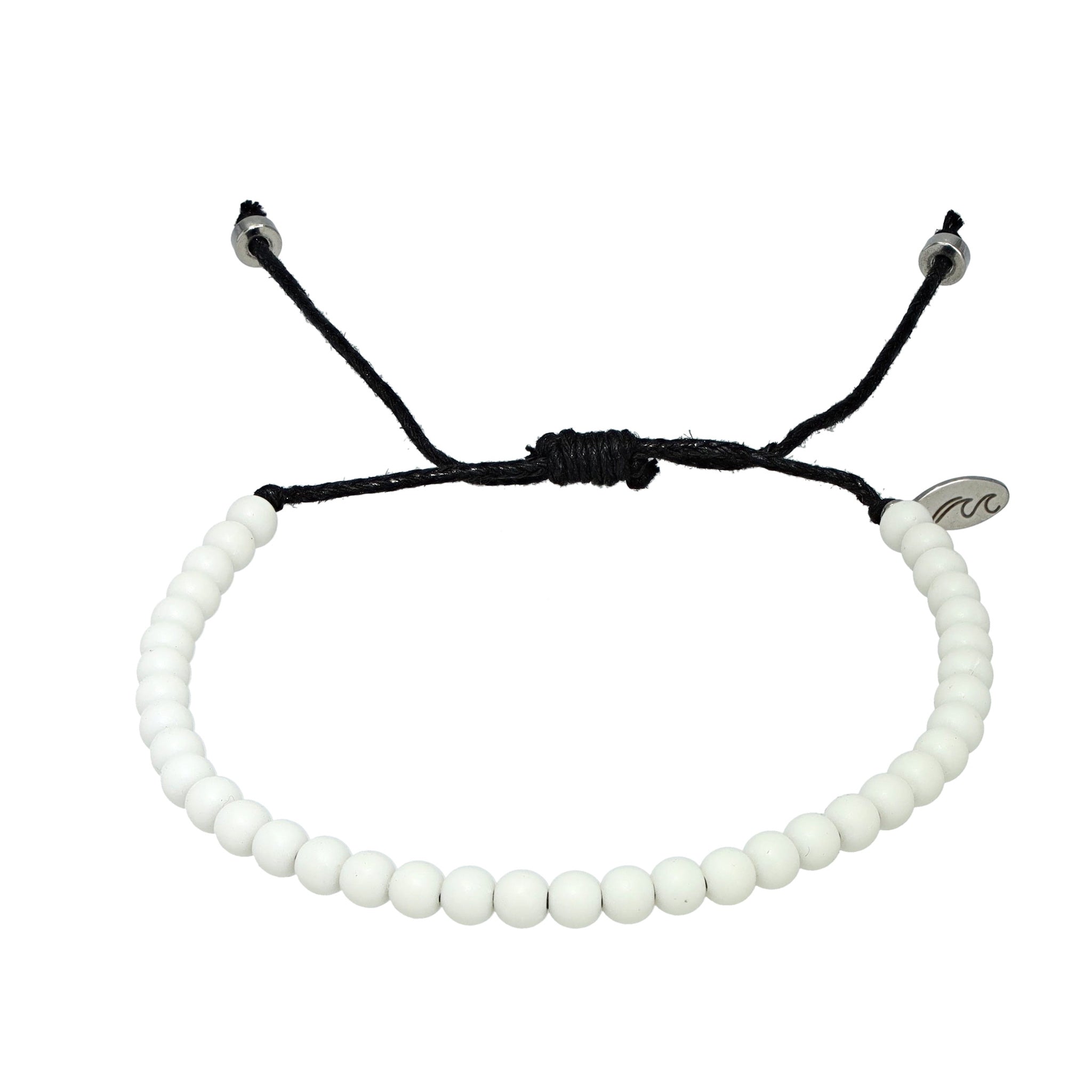 Off-white recycled ocean plastic bracelet featuring a silver charm and durable, adjustable cord. Eco-friendly and handcrafted in Bali.
