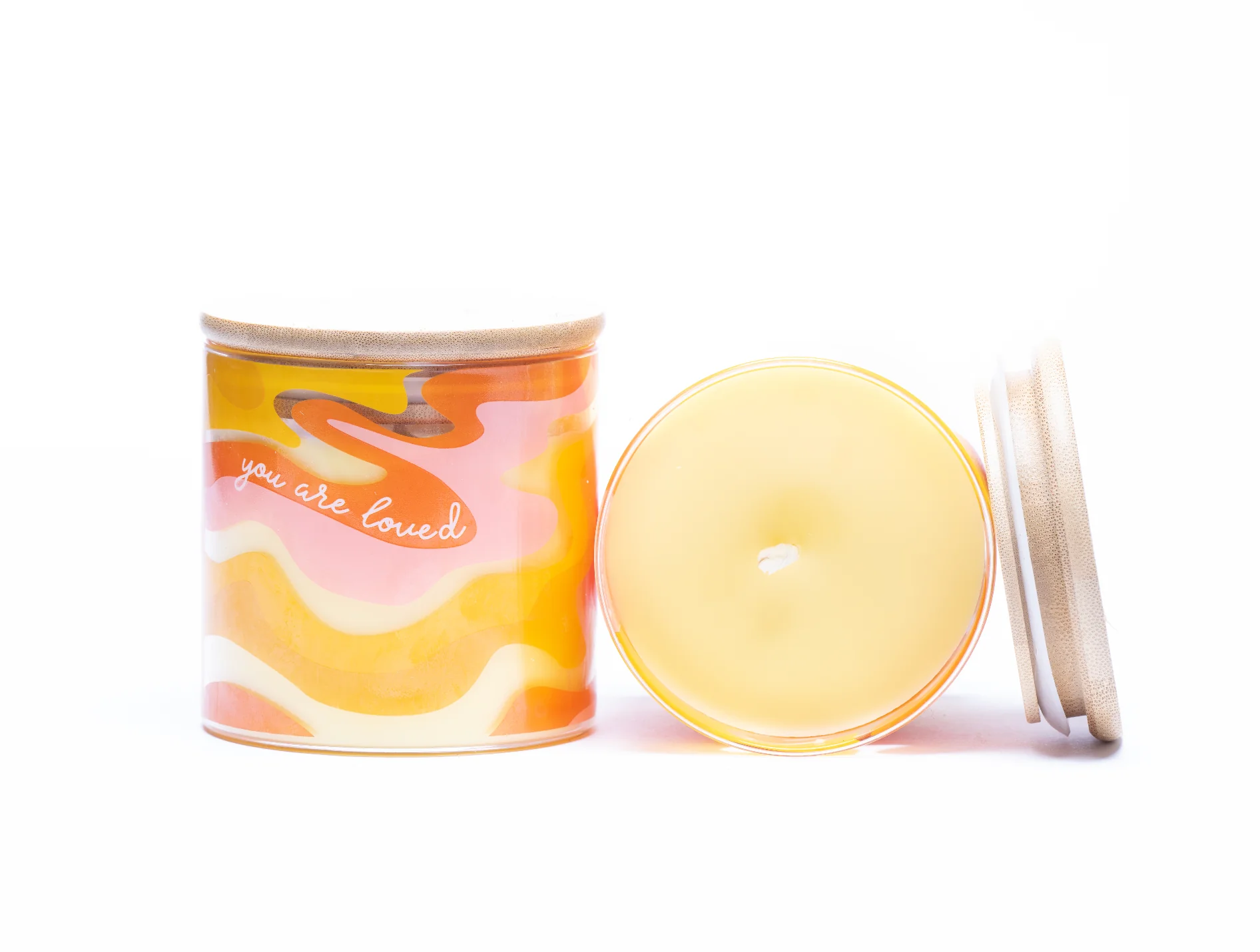 Soy wax candle in a clear glass tumbler with a label that reads “You Are Loved.” Hand-poured in the USA with a clean-burning essential oil blend of lemongrass, lemon, orange, copaiba, cedar, and lavender.
