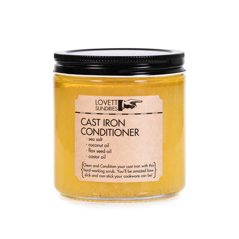 A glass jar with a black lid filled with a yellow substance. A label on the front reads "Lovett Sundries" and "Cast Iron Conditioner".