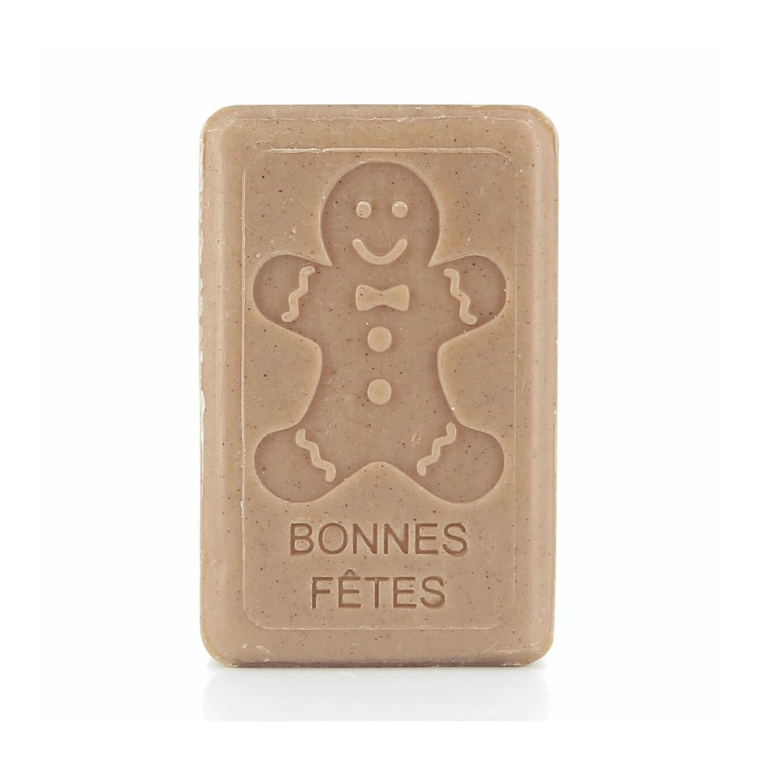 A brownish soap bar with an embossed gingerbread man and the French phrase "Bonnes Fêtes" below.