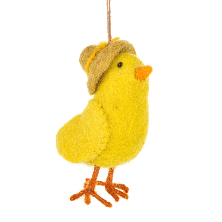 A handmade felt hanging ornament of a yellow chick wearing a tan floppy hat is shown. It has an orange beak and feet.