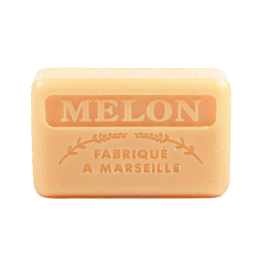 A melon-colored French soap bar with embossed text reading "Melon" and "Fabriqué a Marseille" on a white background.