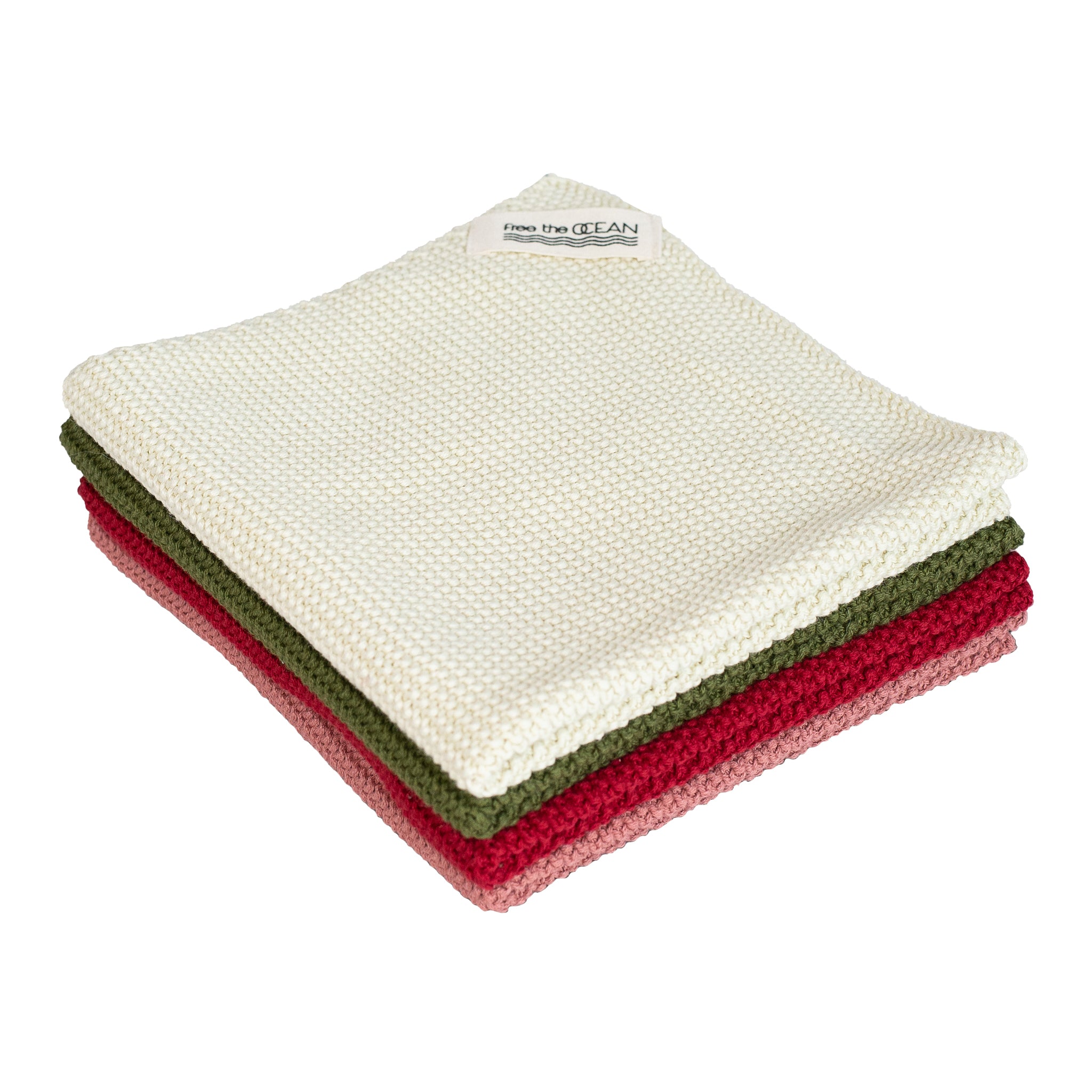 A stack of four rectangular cleaning cloths with a waffle texture. From top to bottom they are light cream, olive green, dark red and muted rose.
