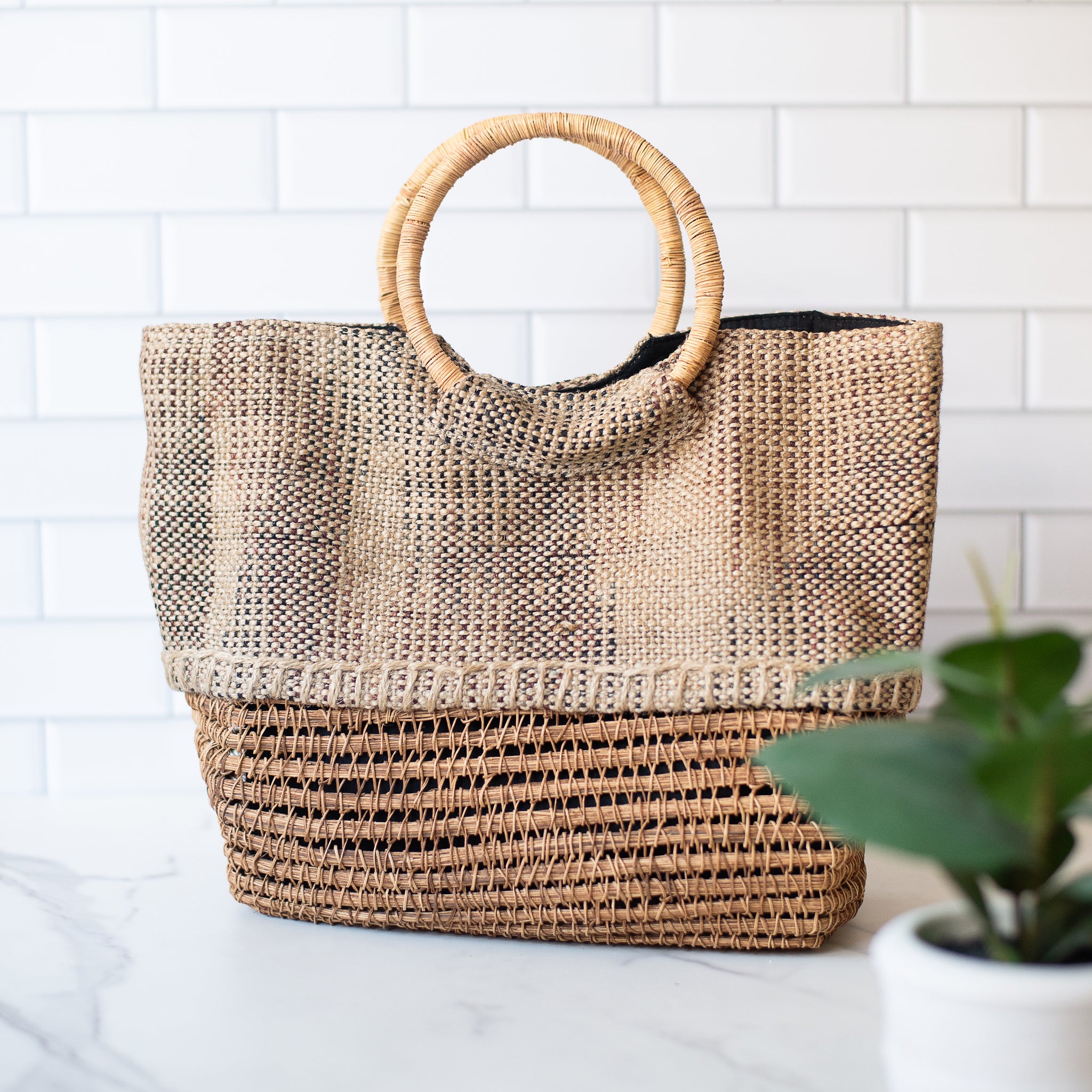 Lifestyle photo of  the palm fiber tote handbag with cotton lining. Designed for beach days, markets, or everyday outings with sustainable style.