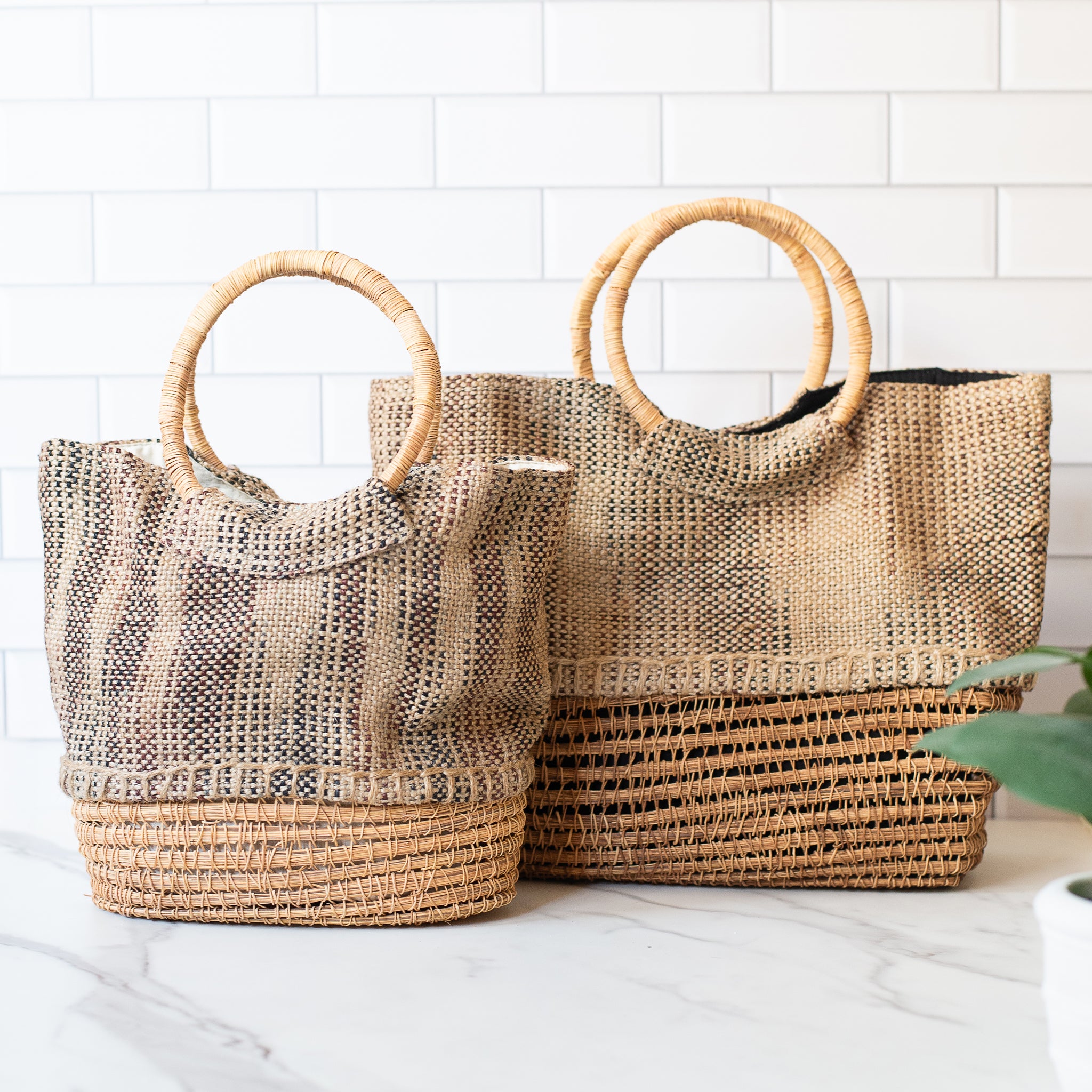 Set of two palm fiber totes in different sizes, crafted by hand from sustainably harvested materials. Includes soft cotton lining and reinforced handles for everyday use.