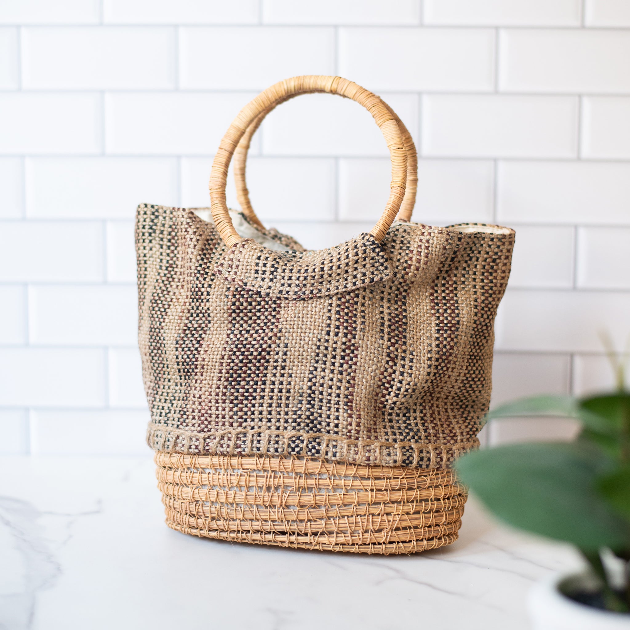 Lifestyle photo of  the palm fiber tote handbag with cotton lining. Designed for beach days, markets, or everyday outings with sustainable style.