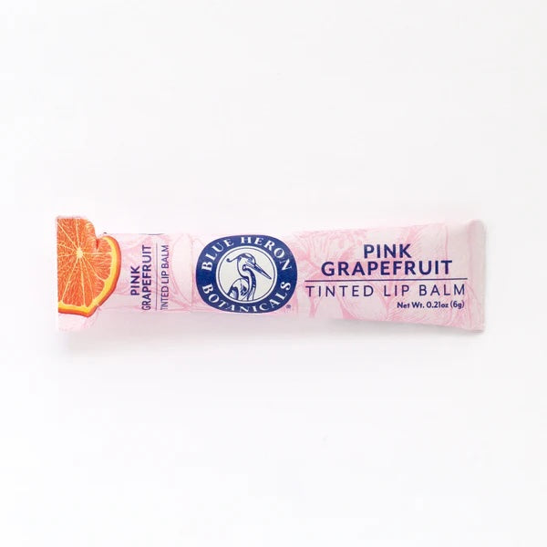 Pink Grapefruit Lip Therapy Balm, crafted with beeswax and botanical oils, in home-compostable packaging made from 100% PCW recycled paperboard.