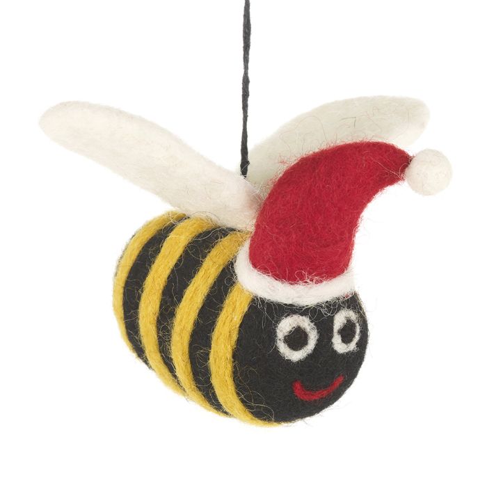 A handmade felt bee is shown wearing a red Santa hat and white wings.