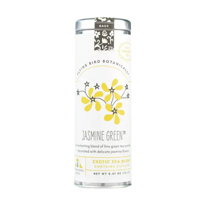 A metal tin of Flying Bird Botanicals' "Jasmine Green" tea is shown, featuring a label with an illustration of elegant yellow flowers. The label notes that this exotic blend "CONTAINS CAFFEINE" and is made with delicate jasmine flowers.