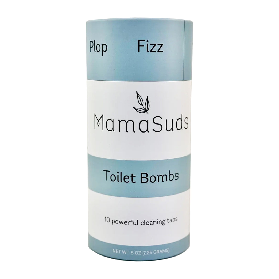 A brown kraft paper pouch labeled “Toilet Bombs” by MamaSuds, shown on a white background. The packaging notes natural, plastic-free cleaning with peppermint, tea tree, and lemon essential oils.
