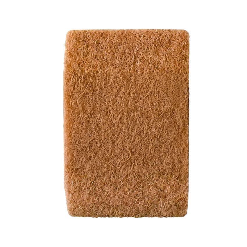 A natural sponge made of sustainably sourced coconut fiber and white cellulose, placed against a clean white background, showing its porous texture and eco-conscious composition.