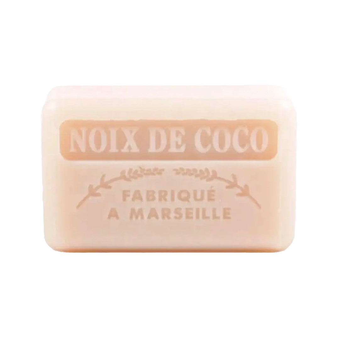 An off-white French soap bar with embossed text reading "Noix de Coco" and "Fabriqué a Marseille" on a white background.