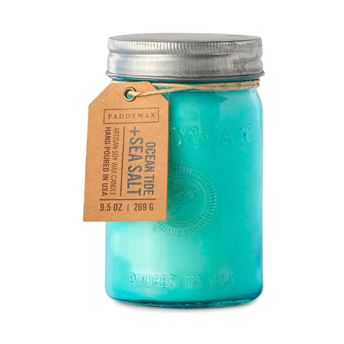 A teal Paddywax artisan soy wax candle is shown in a jar with a metal lid and a tag. The tag identifies it as "Ocean Tide + Sea Salt" and hand-poured in the USA.