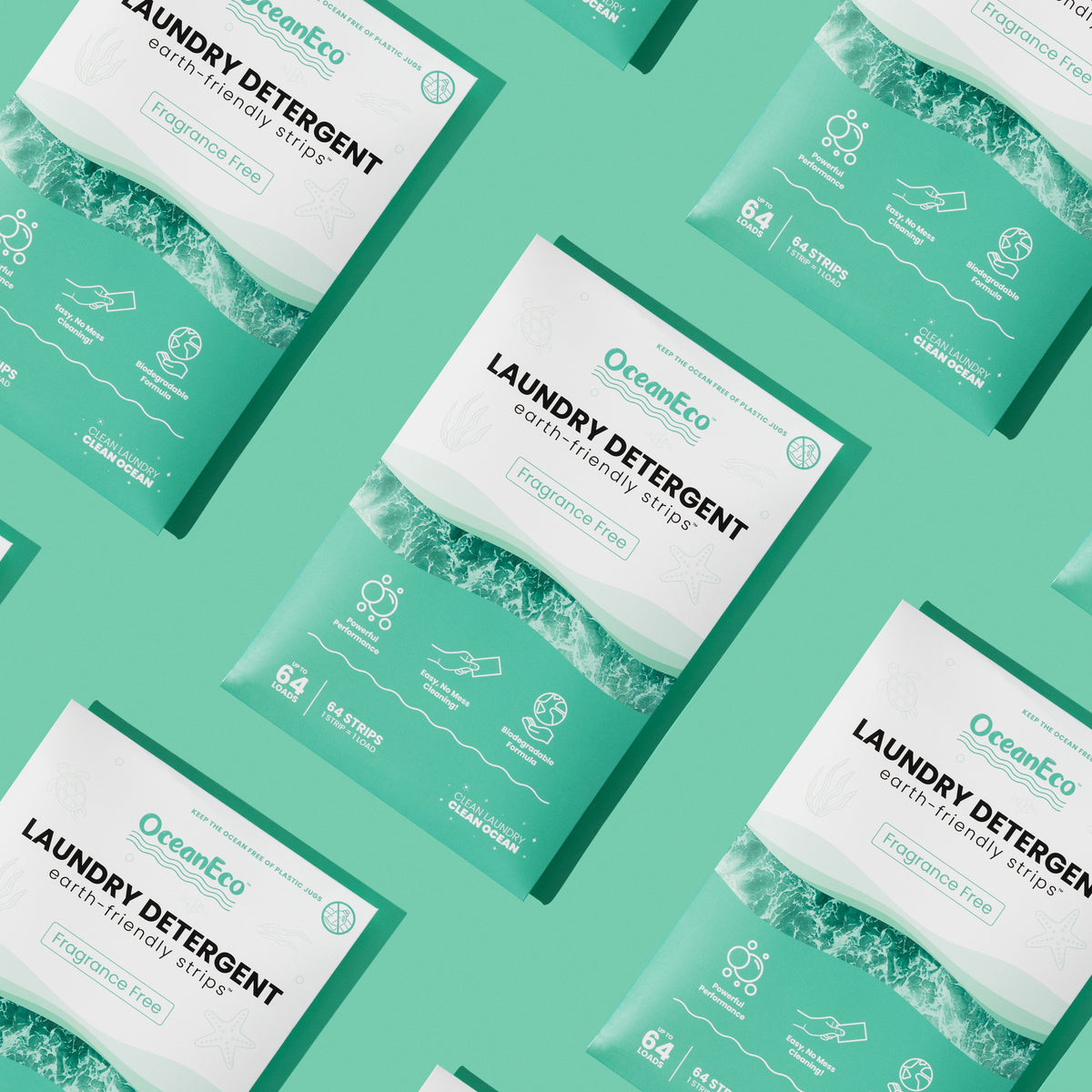 Multiple green OceanEco Laundry Detergent Strips fragrance-free boxes arranged diagonally on a green background, showcasing the eco-friendly packaging and branding.