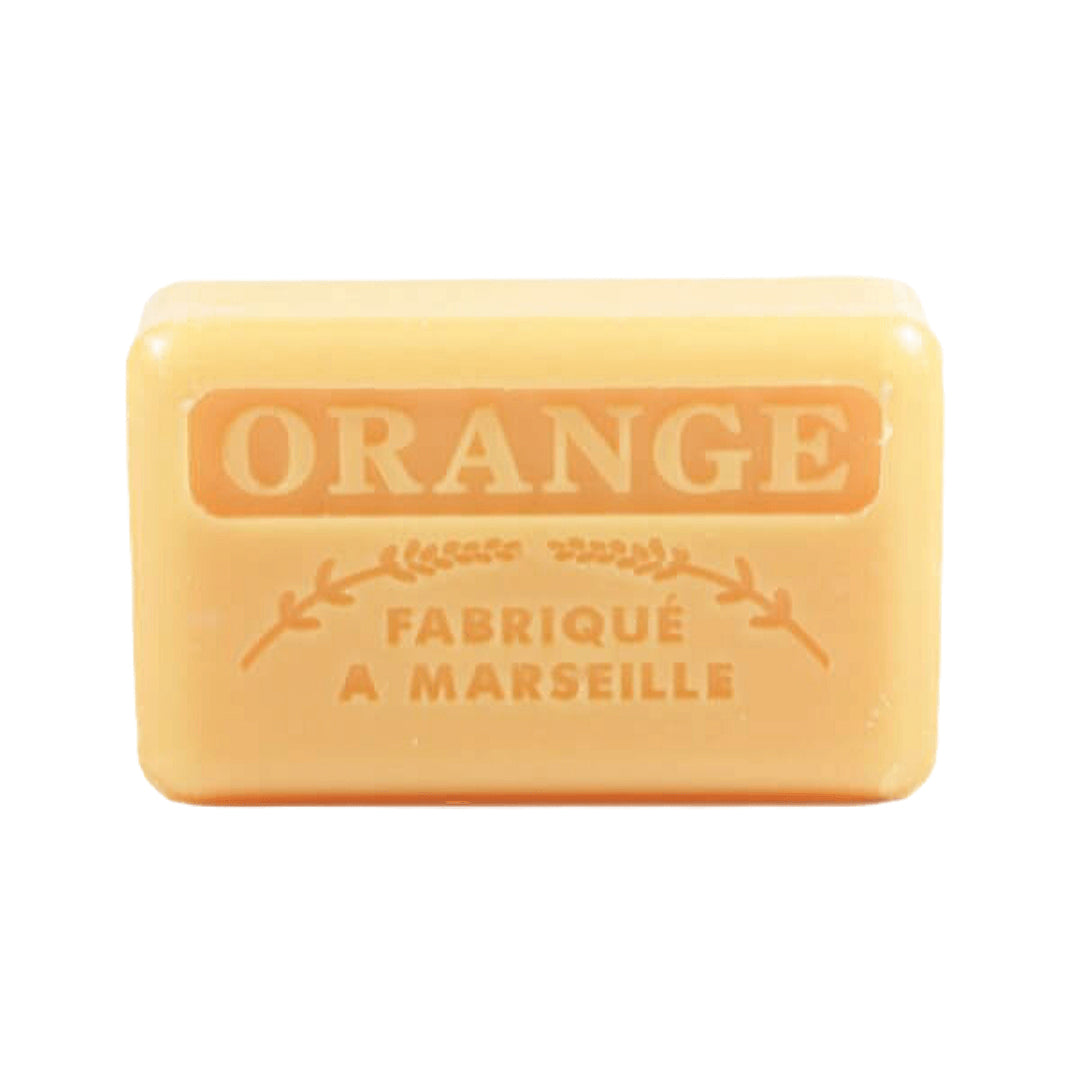 An orange-colored French soap bar with embossed text reading "Orange" and "Fabriqué a Marseille" on a white background.