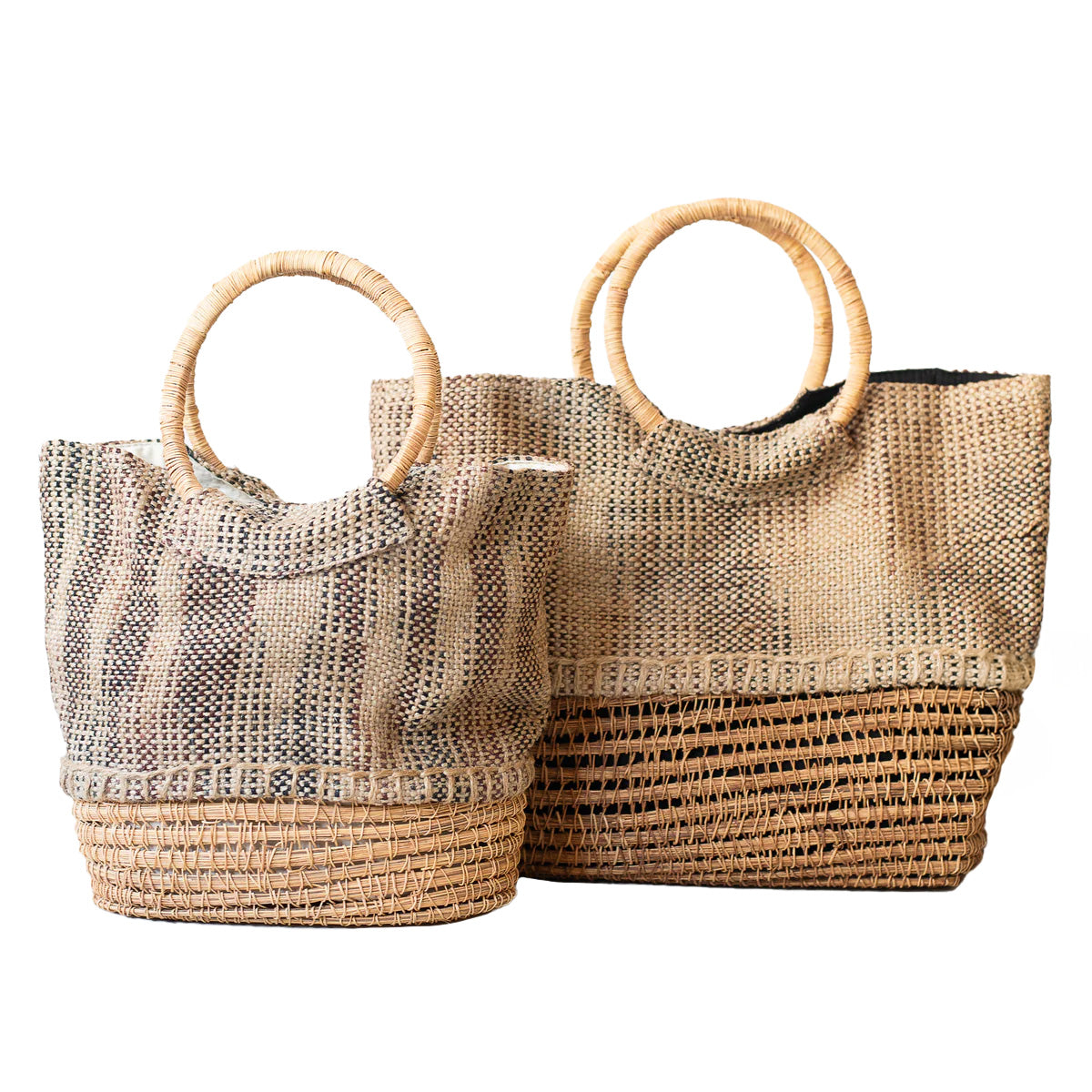 Pair of handmade palm fiber tote bags in small and large sizes, featuring durable handles and a structured, eco-friendly design. Lined with soft cotton and fairly traded from Bangladesh.