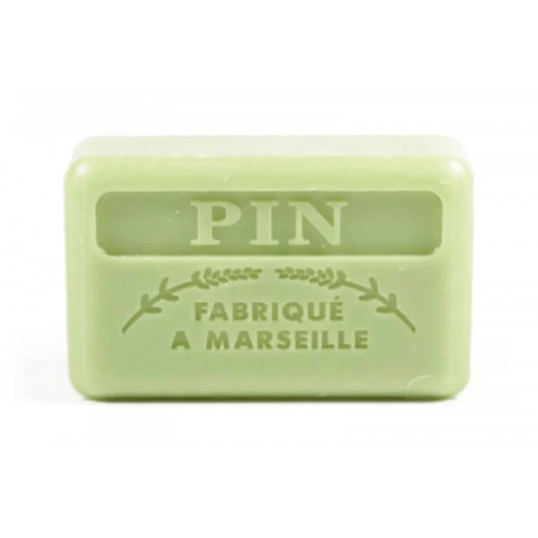 A pale green French soap bar with embossed text reading "Pin" and "Fabriqué a Marseille" on a white background.