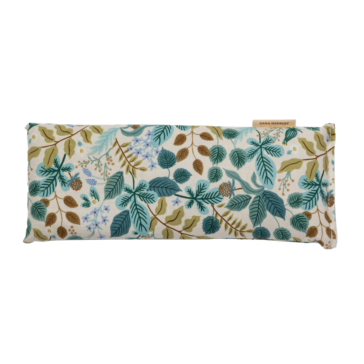 A rectangular eye pillow by Dana Herbert has a botanical pattern with teal and brown leaves and light blue flower clusters.