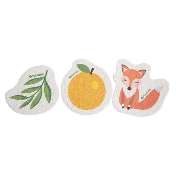 Three fun pop-up sponges are shown on a white background, shaped like a leaf, an orange and a fox. Each sponge is labeled PLANTISH.