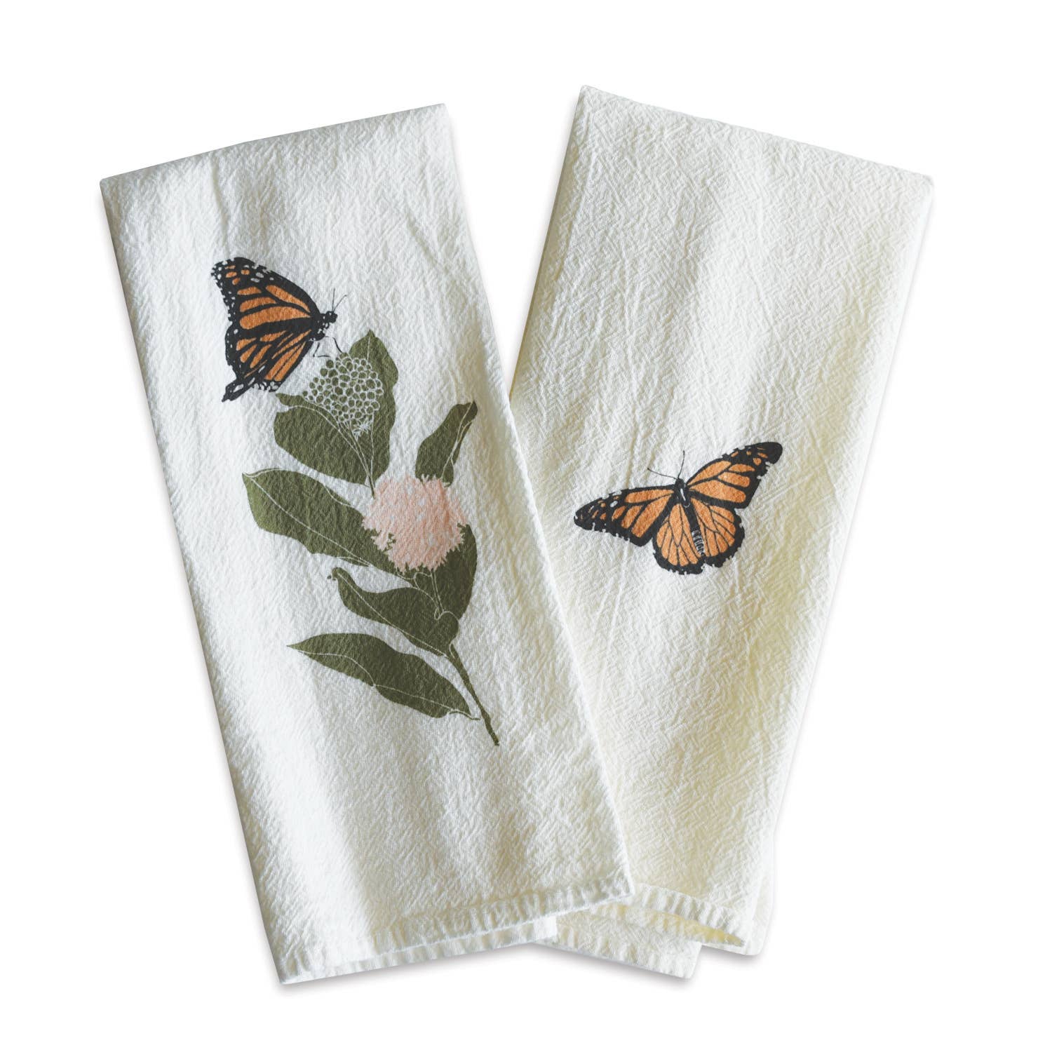 A lovely pair of white napkins is shown folded, each with a monarch butterfly design. One towel features a butterfly resting on a leafy green branch with a pink flower, while the other has a single butterfly.