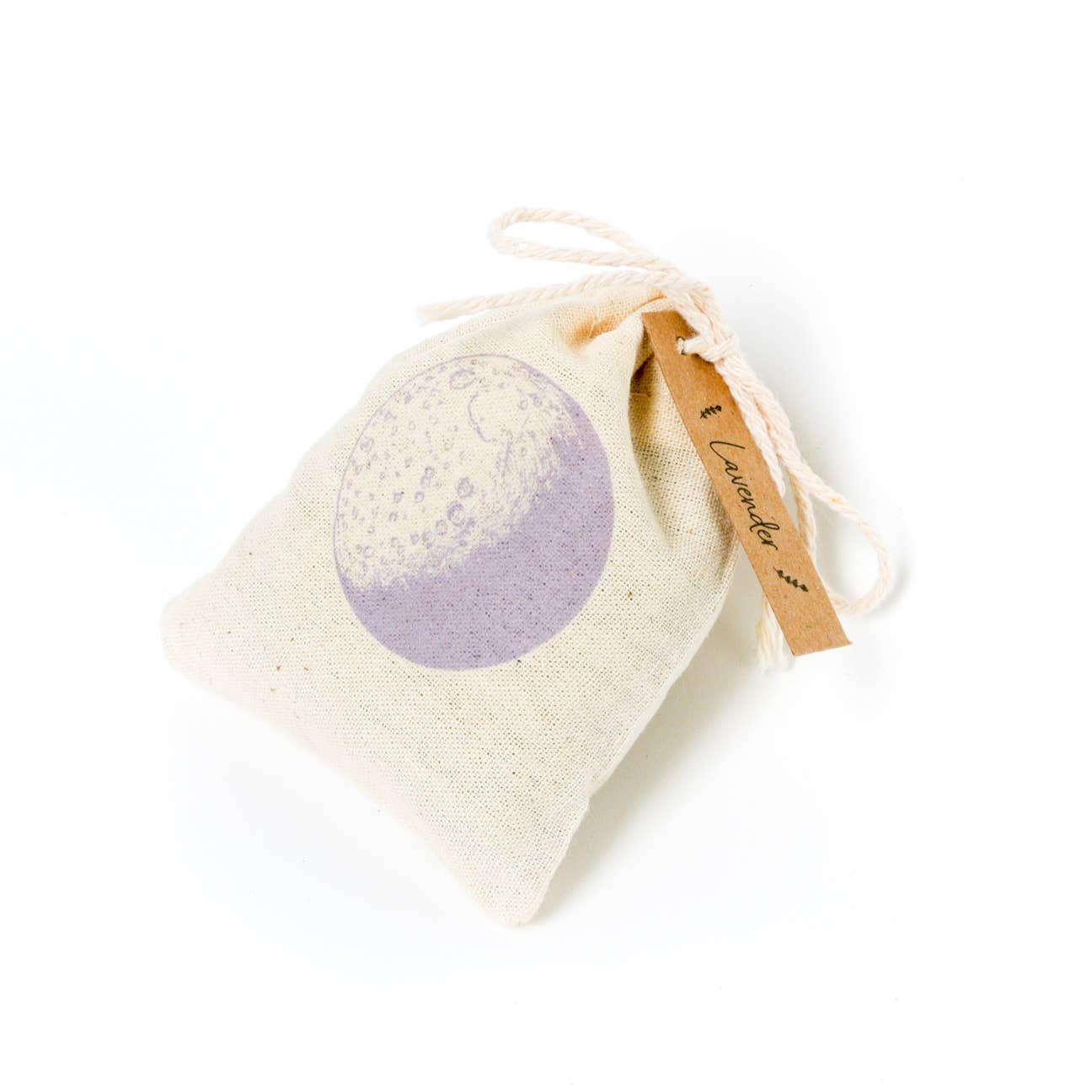 A small, light-colored fabric sachet is shown, tied at the top with a string and featuring a purple, moon-like illustration on the front. A small paper tag tied to the sachet has "Lavender" written on it.