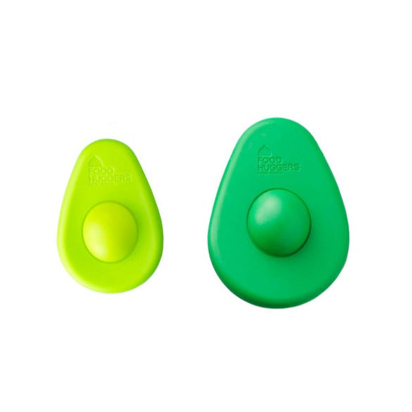 A cute pair of Avocado Huggers, a small light green one and a large dark green one, are shown side-by-side to highlight the size comparison.