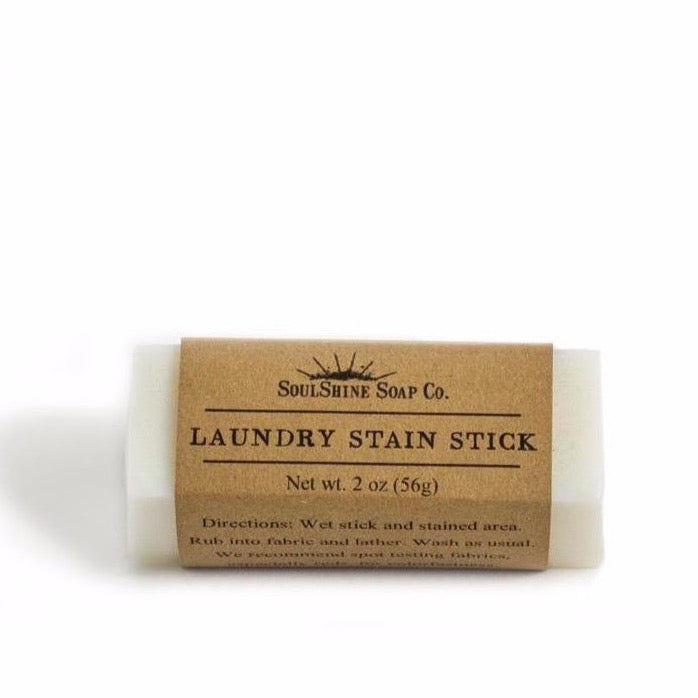 Organic Laundry Bar SoapA plastic-free Stain Stick Bar made of coconut oil, resting on a white surface beside its brown kraft paper label.