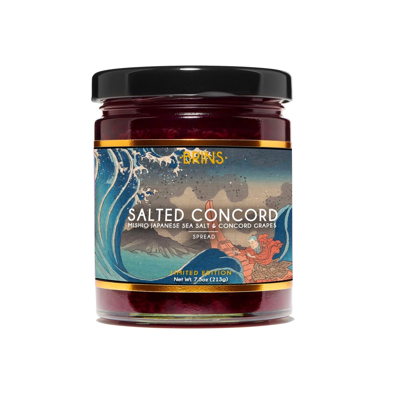 A jar of red-colored Brins Salted Concord spread is shown on a white background. The label has an artistic design with a wave, a boat and a person. The label identifies the spread as containing Mishio Japanese sea salt and Concord grapes.