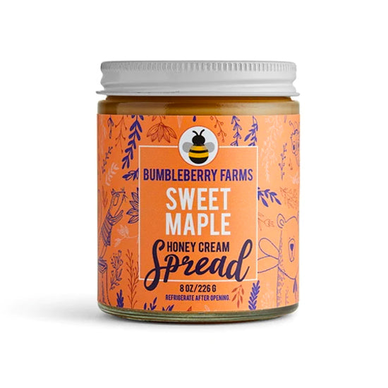 A jar of Bumbleberry Farms Sweet Maple Honey Cream Spread is shown with a white lid and an orange label with purple designs. The label includes the brand name, the flavor "Sweet Maple" and indicates the jar contains 8 oz. of the product.