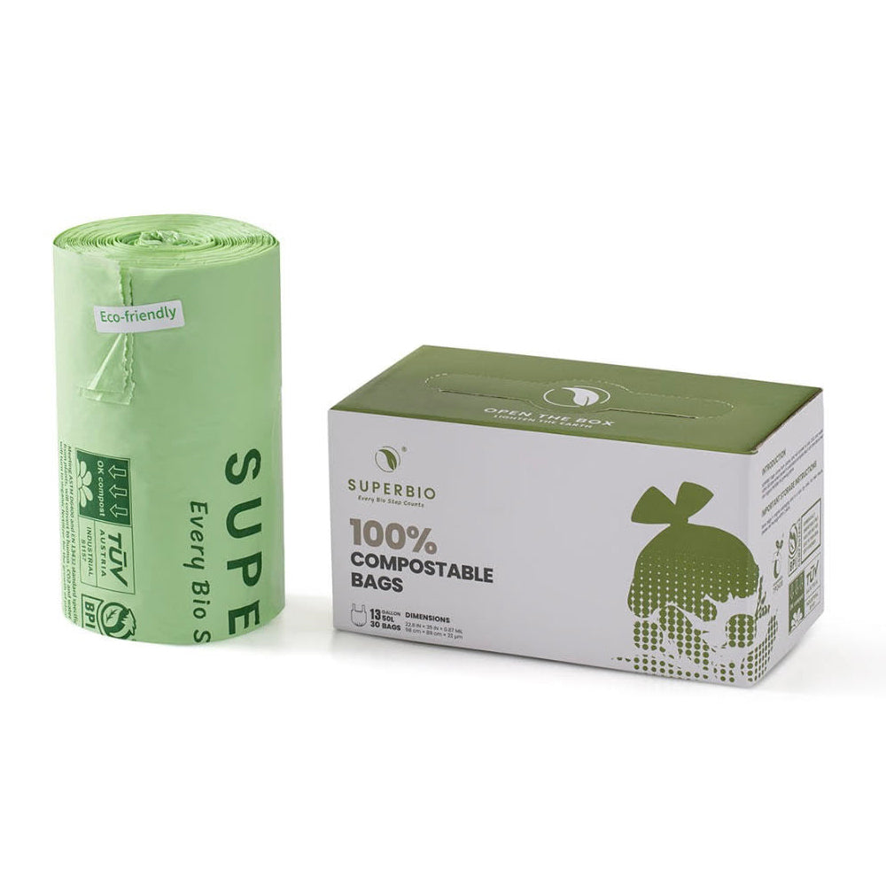 A rolled-up green compostable bag is shown next to its cardboard box on a white background. Both the bag and the box are branded with the SUPERBIO logo and the box states that it contains 100% compostable bags.
