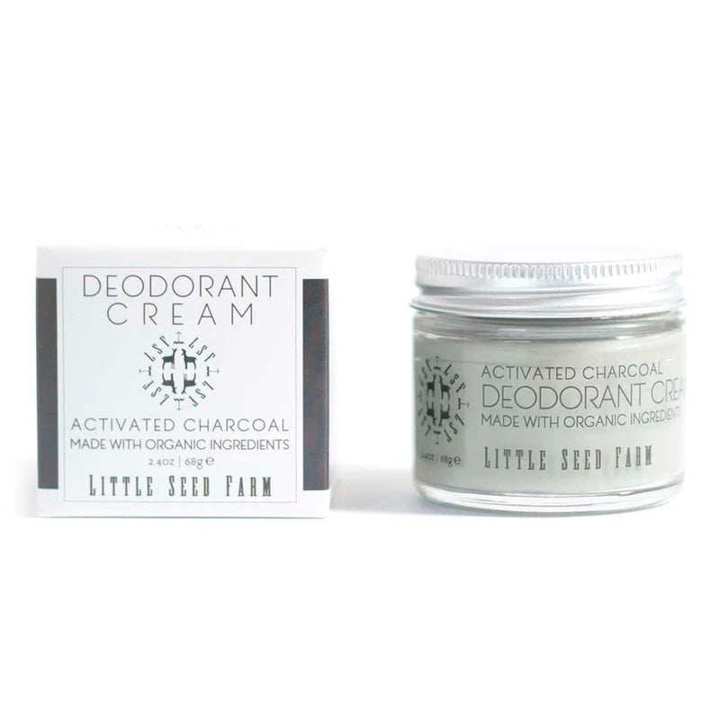 A jar of gray Little Seed Farm Activated Charcoal deodorant cream is next to its box. Made with organic ingredients.