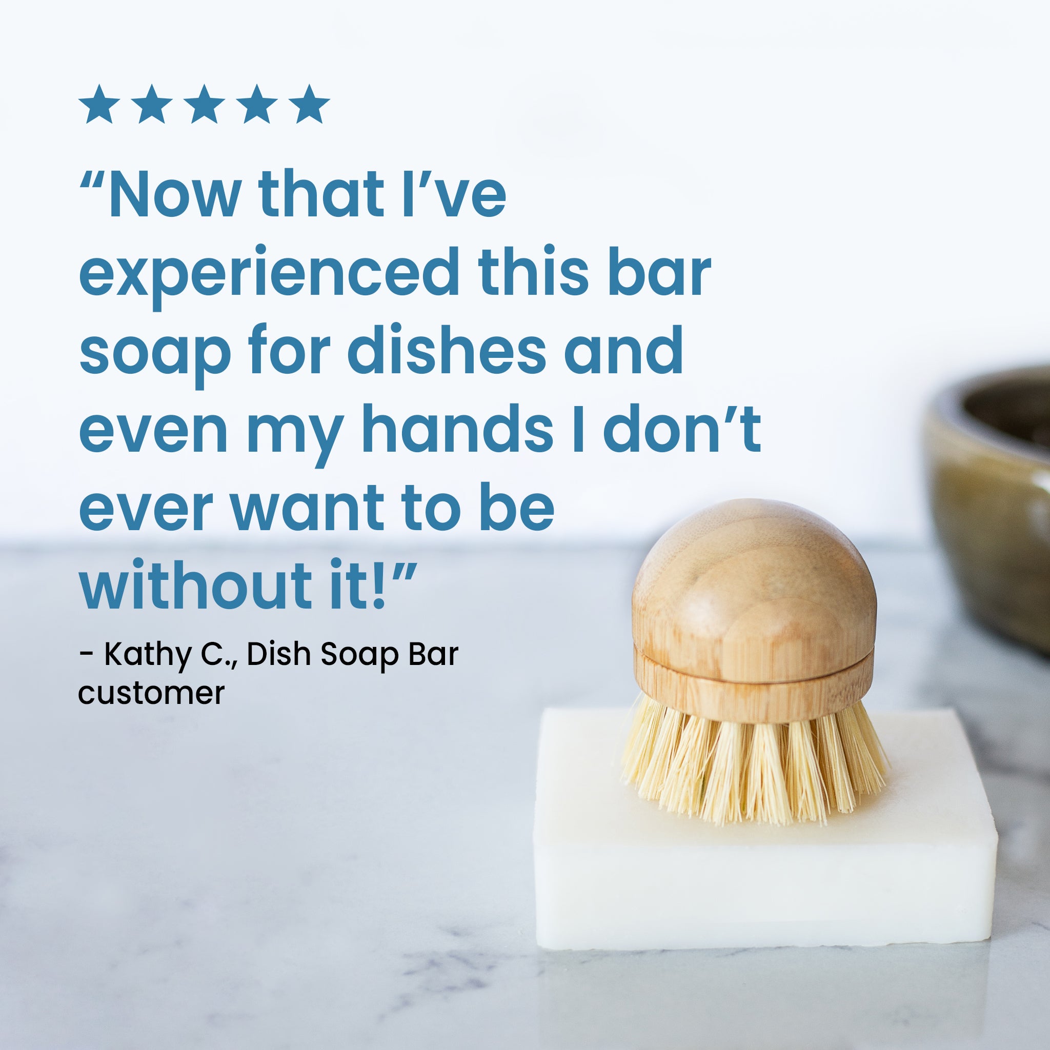 White rectangular dish soap bar with a bristle dish brush resting on top, accompanied by a customer quote: ‘Now that I’ve experienced this bar soap for dishes and even my hands, I don’t ever want to be without it.’