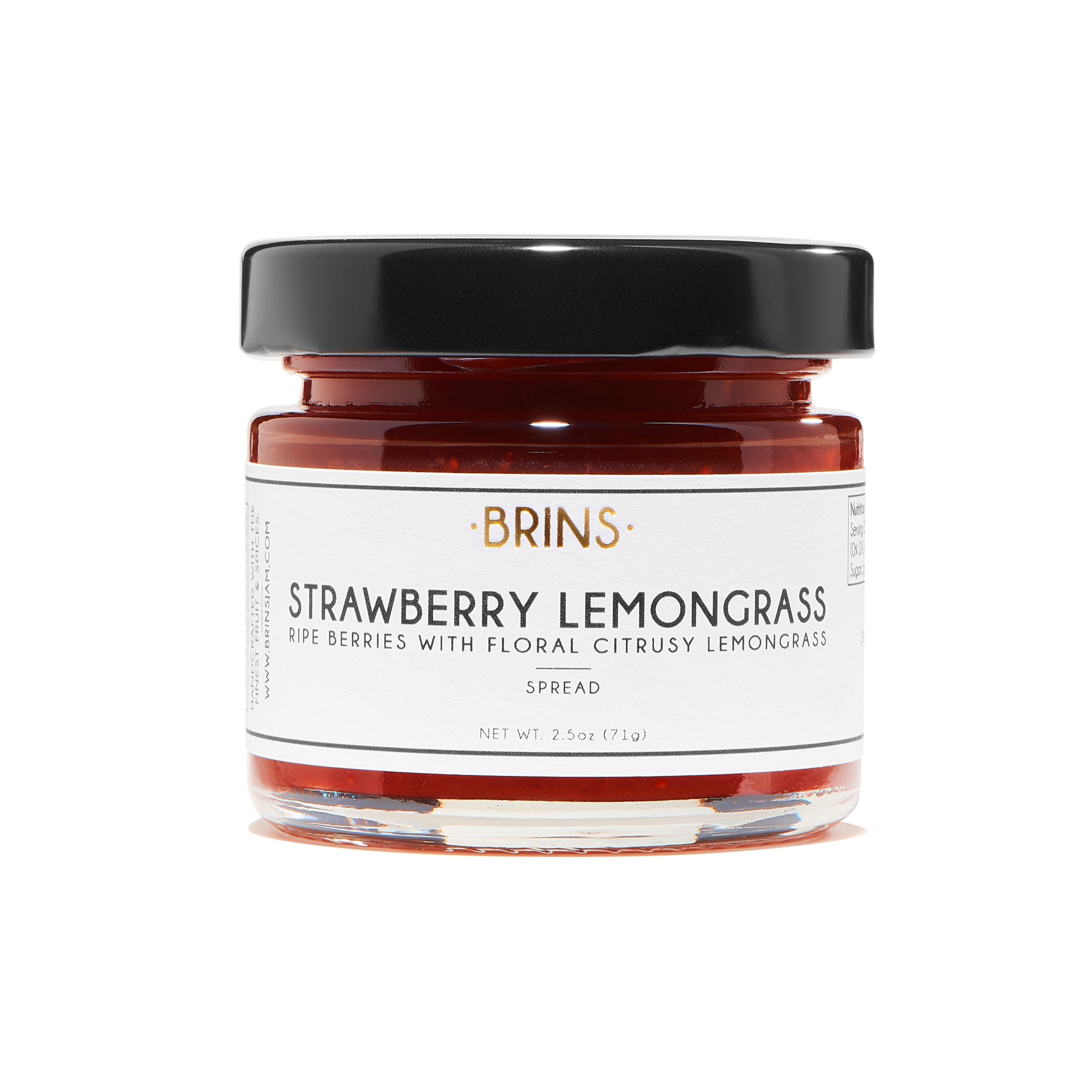 A small glass jar of "BRINS" Strawberry Lemongrass spread with a black lid. The white label features the brand name, with the flavor and a description, "RIPE BERRIES WITH FLORAL CITRUSY LEMONGRASS". The sweet red spread is visible inside the jar.