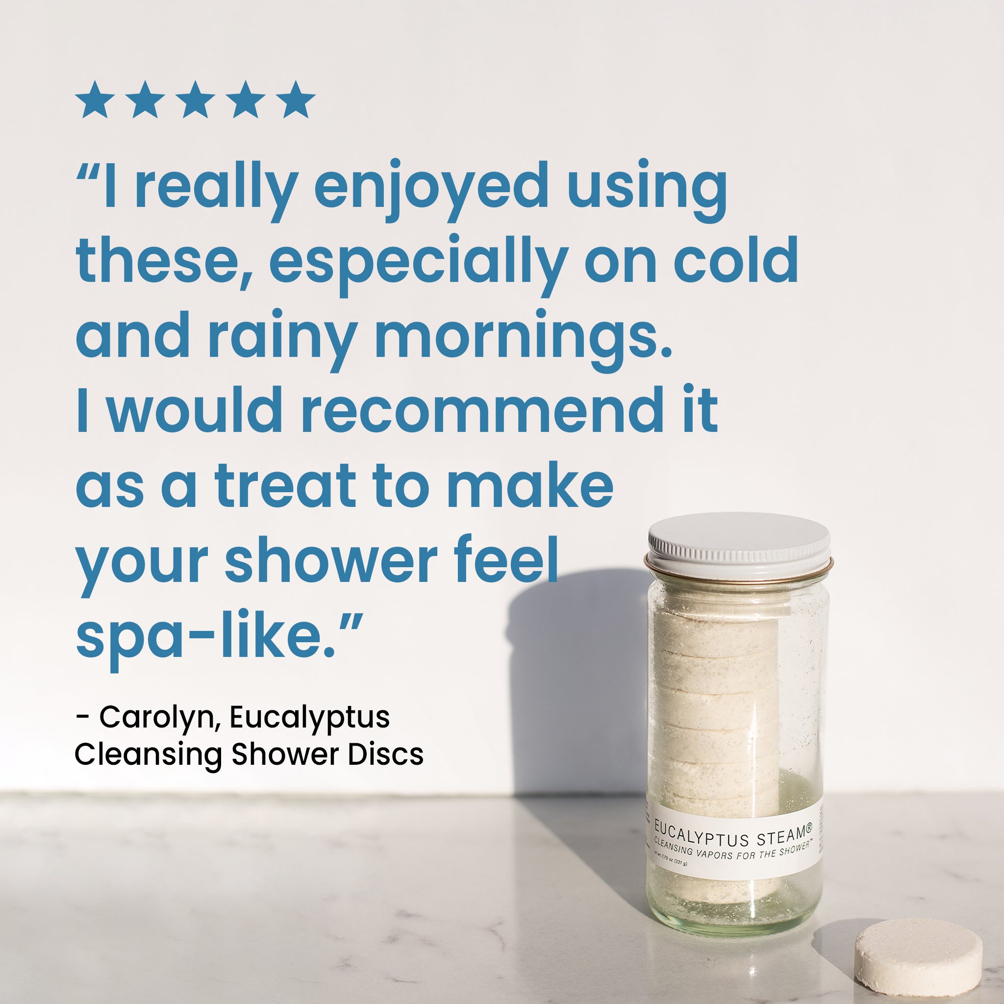 A five-star product review with a quote that reads: "I really enjoyed using these, especially on cold and rainy mornings. I would recommend it as a treat to make your shower feel spa like." Next to the review is a glass jar of 'Eucalyptus Steam' cleansing vapors.