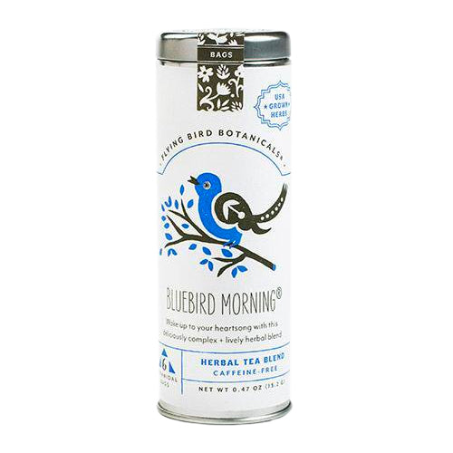 A metal tin of Flying Bird Botanicals' "Bluebird Morning" herbal tea, featuring a label with a charming illustration of a bluebird on a branch. The tea is a "CAFFEINE FREE" blend made with "USA GROWN HERBS".