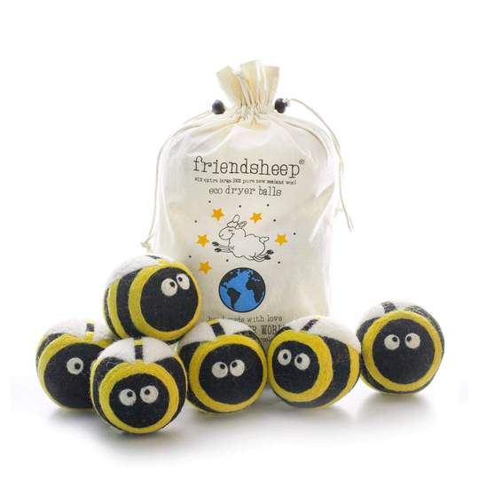 Close-up of 6-pack Friendsheep wool dryer balls with soft pastel tones and sheep-shaped decorations, shown alongside the natural cotton drawstring bag on a neutral background.
