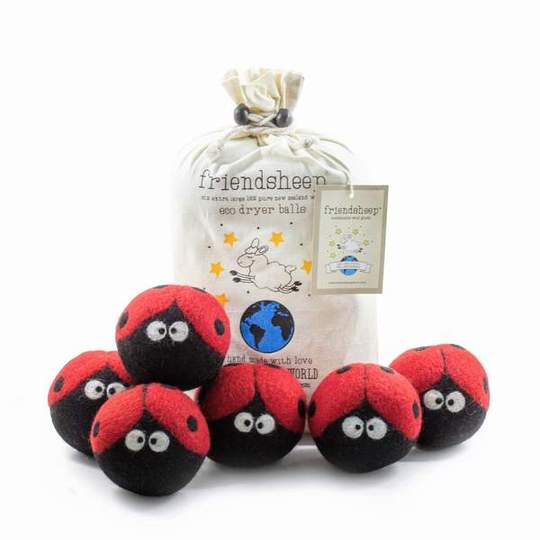 Six wool dryer balls decorated with red and black ladybugs, accompanied by a natural cotton drawstring bag, arranged on a neutral background. Made from organic New Zealand wool, eco-friendly and reusable laundry balls.