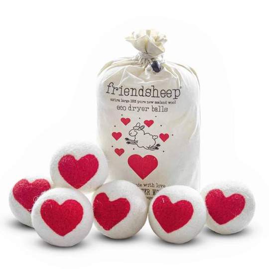 Six wool dryer balls decorated with a sigle red heart, 'Lovely Day' accompanied by a natural cotton drawstring bag, placed on a soft neutral background. Made from organic New Zealand wool, eco-friendly and reusable for laundry.