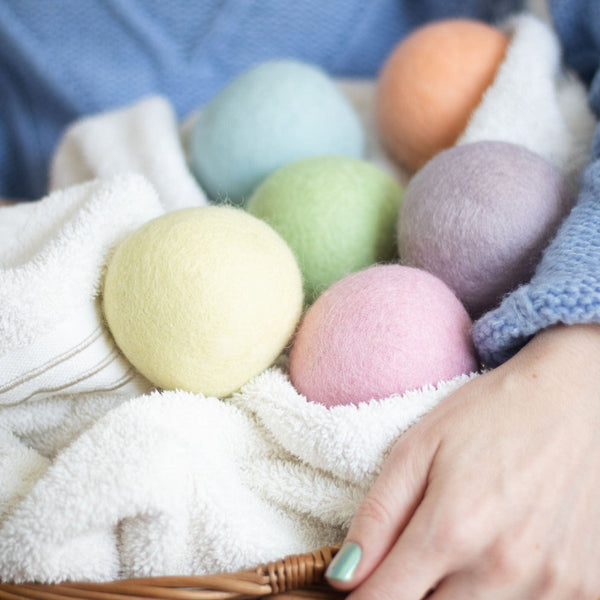 Spring Magic wool dryer balls in pastel colors arranged on towel.