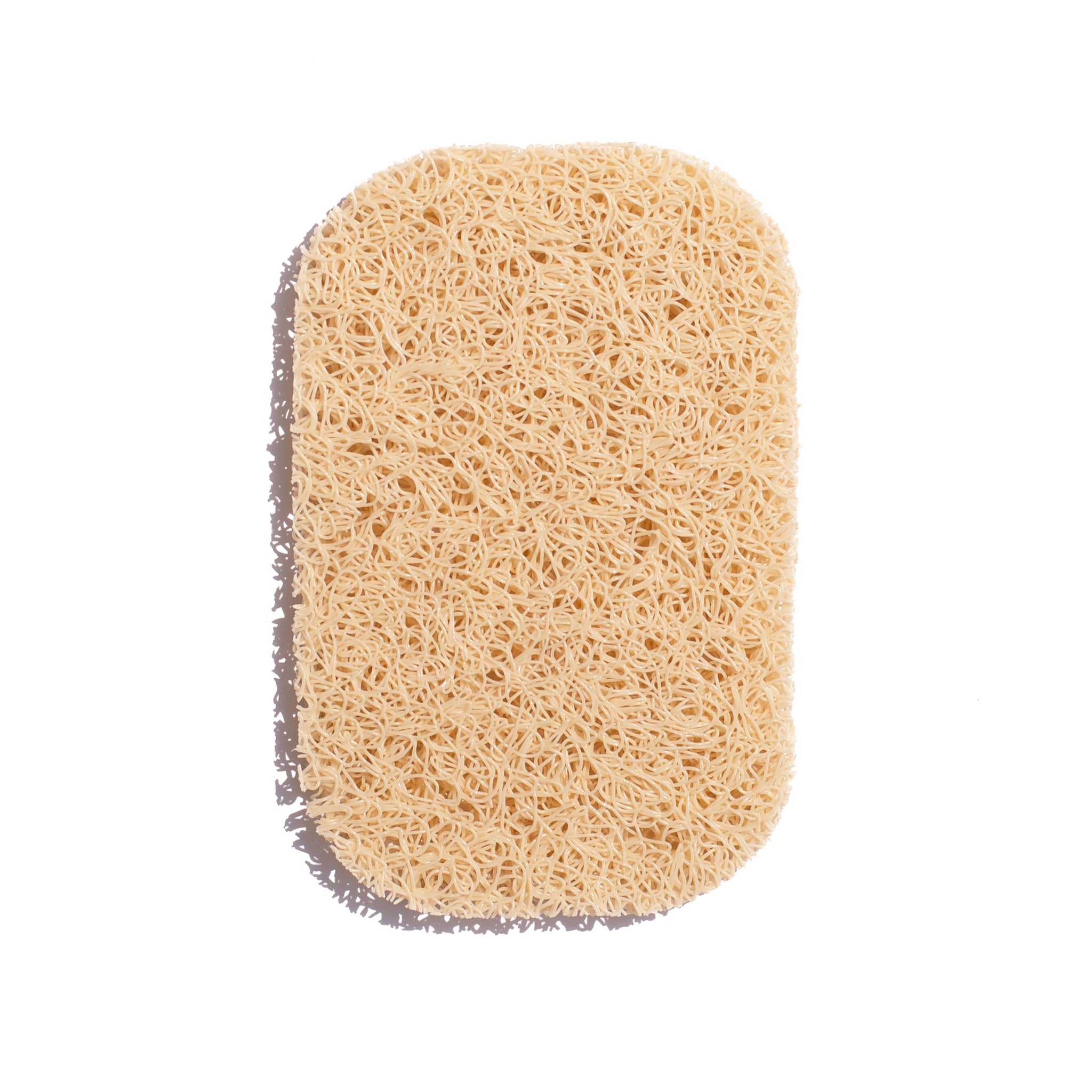 A light beige, oval-shaped soap rest with a textured, porous surface designed to allow soap to dry.