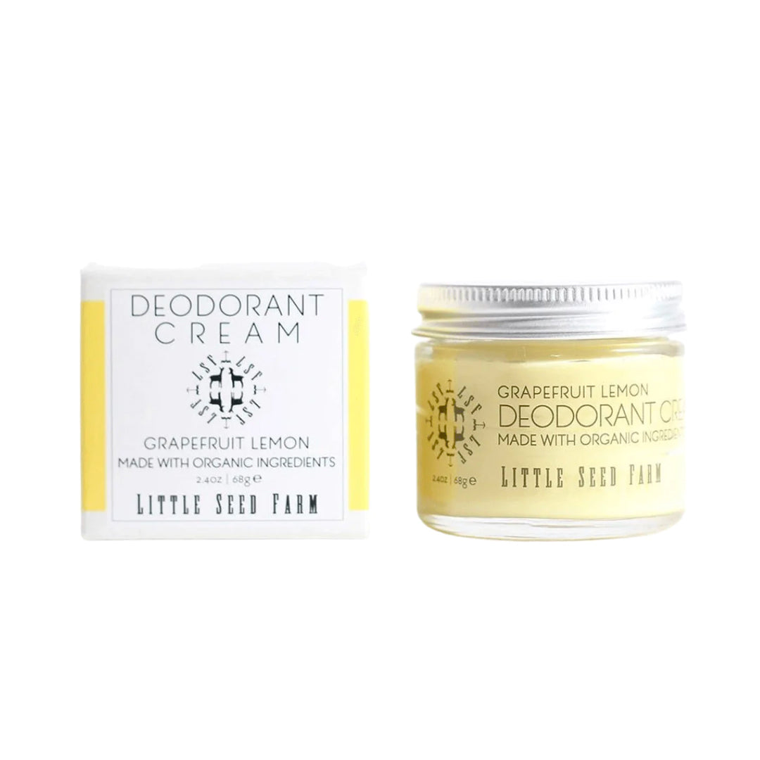 A jar of pale yellow Little Seed Farm deodorant cream is shown next to its product box. The cream is a "Grapefruit Lemon" scent and is made with organic ingredients. The packaging is white and yellow with black lettering and the jar has a silver lid.