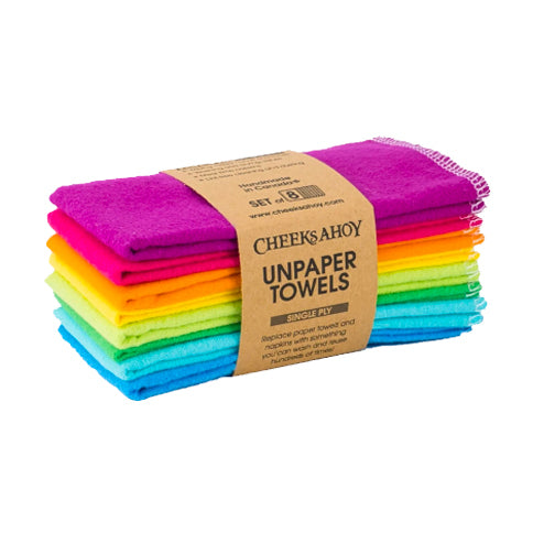 A stack of eight brightly colored cloths arranged in a rainbow pattern is shown wrapped in a brown paper band. The band identifies the product as Cheeks Ahoy Unpaper Towels, which are a set of eight single-ply towels designed to replace paper towels and napkins.