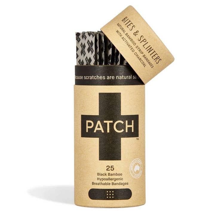 A kraft-paper-style cardboard tube labeled “PATCH,” activated charcoal standing upright on a white background, showcasing eco-friendly packaging for biodegradable bandage strips.