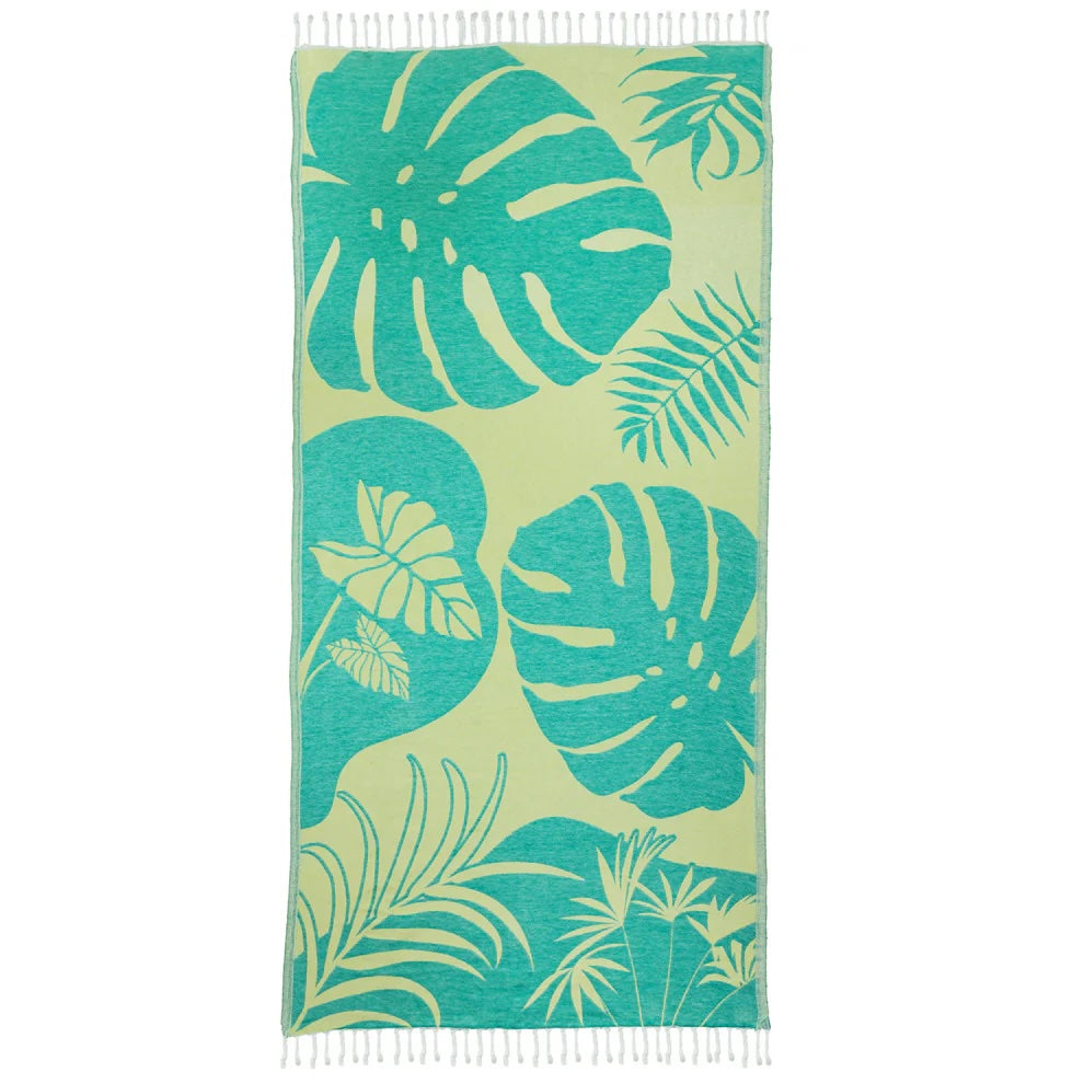 Turkish cotton beach towel with a teal leaf pattern, sand-free and compact for travel or beach days.