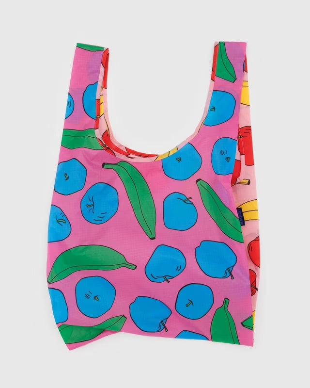 BAGGU reusable bag with playful blue apples and green bananas print in a pink background, made from durable recycled ripstop nylon. Ethically made, lightweight, and designed to replace 2–3 single-use grocery bags.