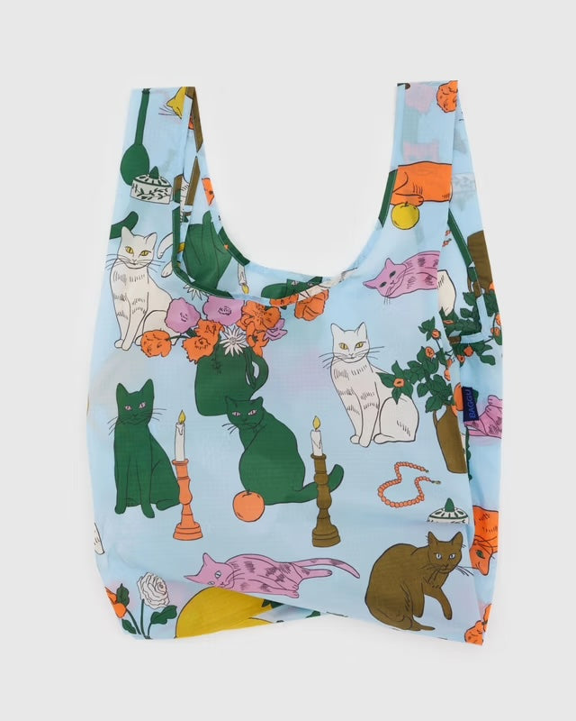 Reusable BAGGU bag featuring a charming green, white, pink and brown cats pattern on a blue background. Strong yet lightweight recycled nylon construction, perfect for everyday carrying.