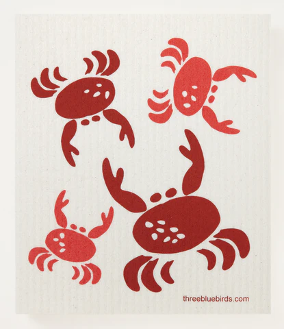 A reusable and compostable dishcloth with bright red crab illustrations