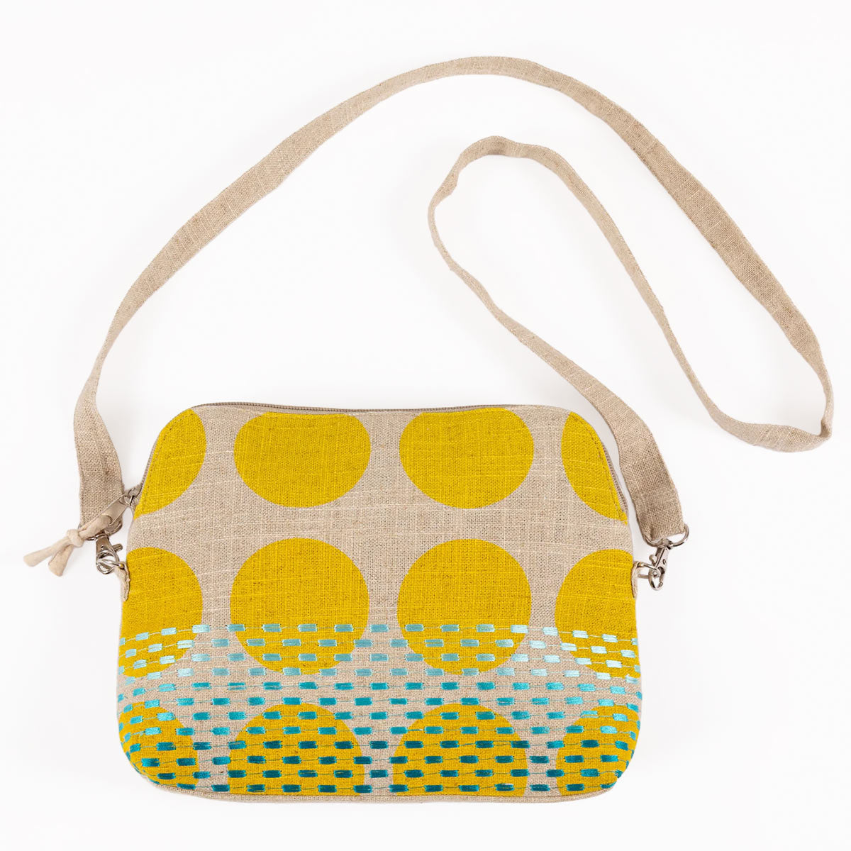 Crossbody bag with yellow polka dot pattern on a beige background