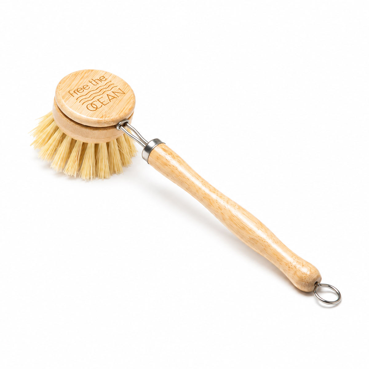 A wooden-handled dish brush with natural bristles and a metal hanging loop, shown on a plain white background. The round wooden head is engraved with the text 'Free the OCEAN'.